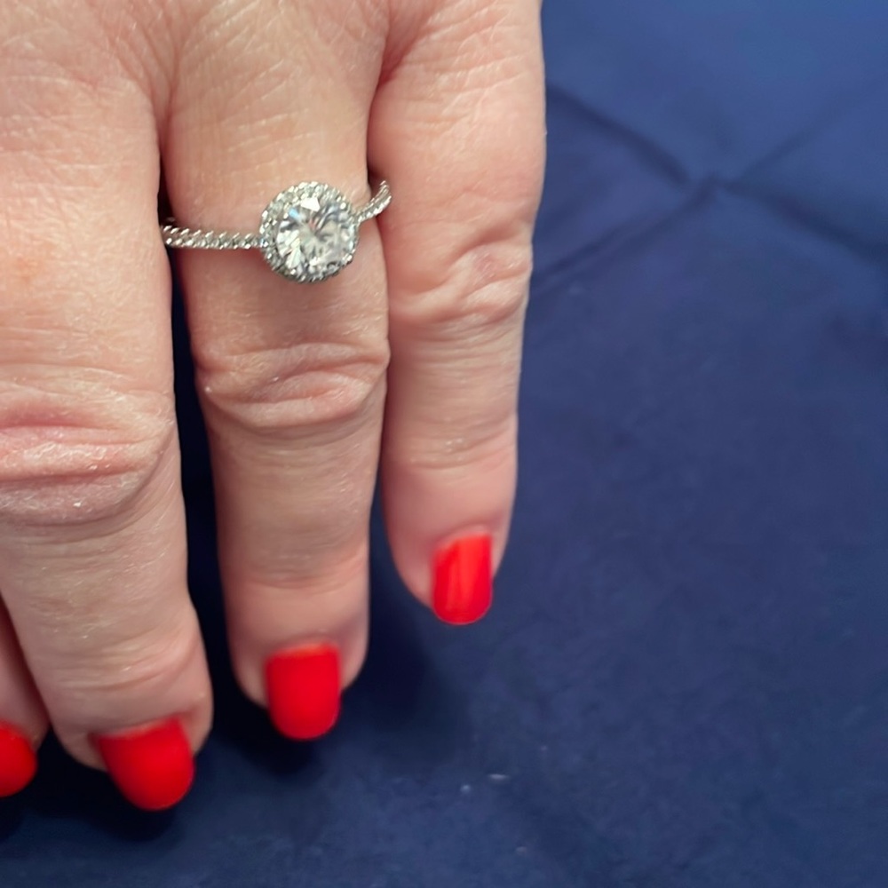 130 facet two carat center stone with halo complementing center stone